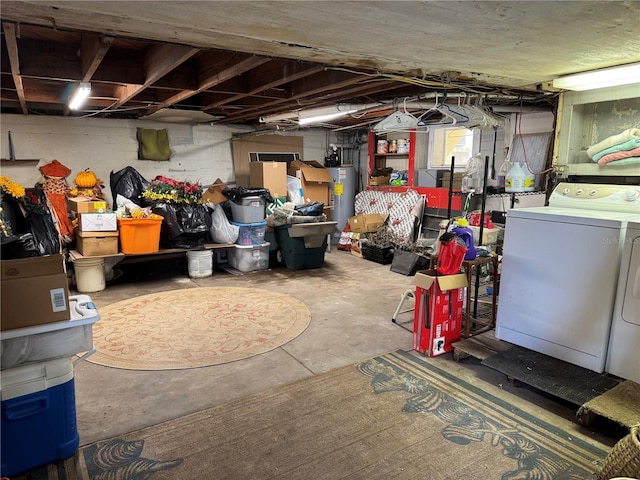 basement with washing machine and dryer and water heater