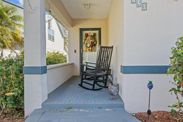 doorway to property featuring covered porch