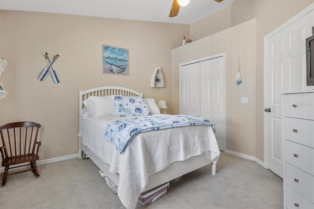 bedroom with a closet, ceiling fan, light colored carpet, and lofted ceiling