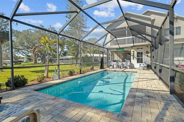 view of swimming pool featuring a yard, a lanai, and a patio area