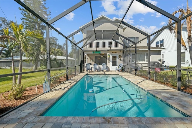 view of pool featuring a patio area, ceiling fan, and a lanai