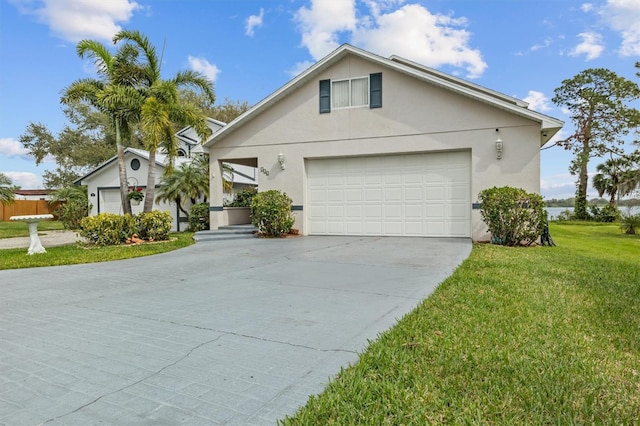 view of front facade with a garage, stucco siding, concrete driveway, and a front yard