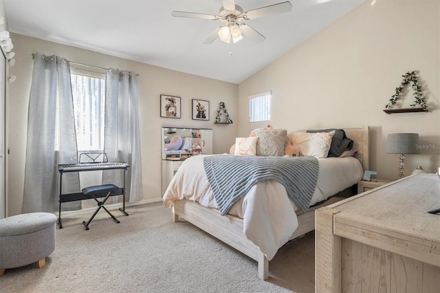 carpeted bedroom with multiple windows, ceiling fan, baseboards, and vaulted ceiling