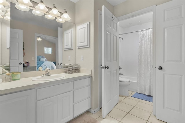bathroom featuring tile patterned floors, shower / bathtub combination with curtain, ensuite bathroom, ceiling fan, and vanity