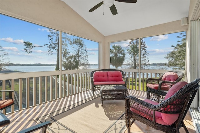 sunroom / solarium with lofted ceiling, a ceiling fan, and a water view