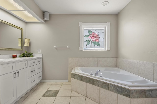 full bathroom featuring tile patterned flooring, a garden tub, vanity, and baseboards