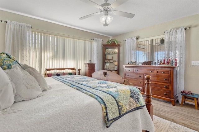 bedroom with ceiling fan and wood finished floors