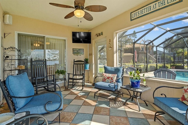 sunroom featuring ceiling fan