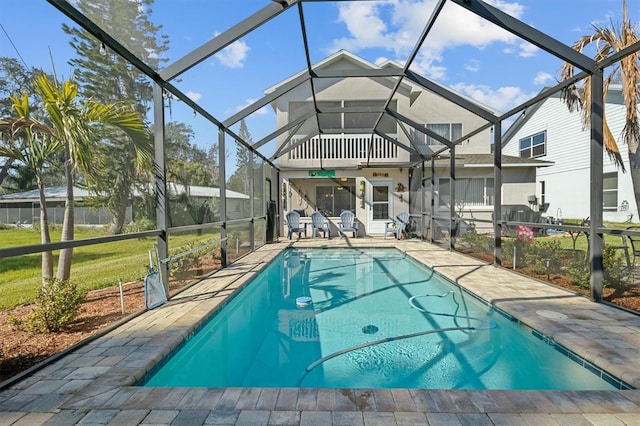 view of swimming pool featuring a fenced in pool, a yard, a lanai, and a patio area