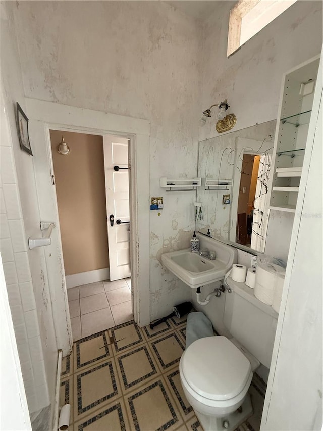 bathroom with sink, tile patterned floors, and toilet