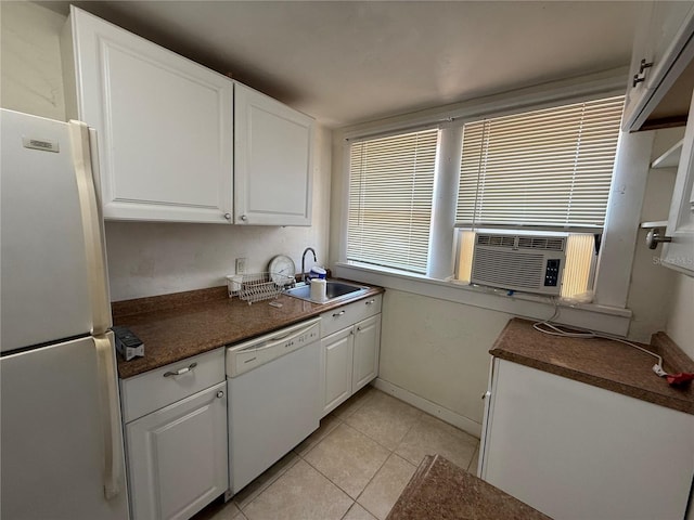 kitchen with sink, light tile patterned floors, fridge, dishwasher, and white cabinets