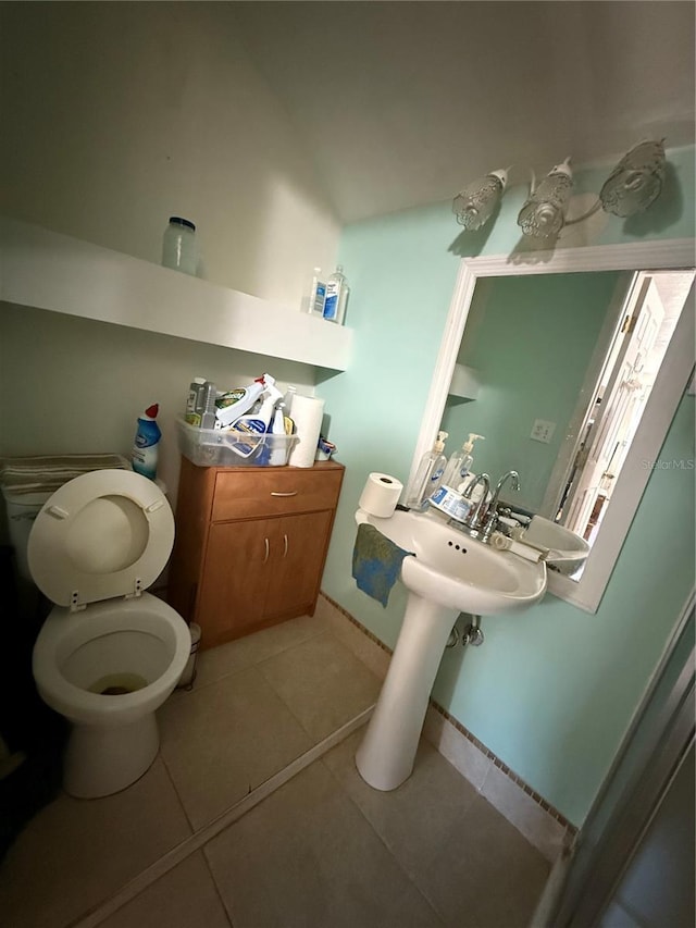 bathroom featuring tile patterned flooring, sink, and toilet