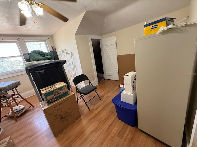 interior space featuring ceiling fan, a textured ceiling, and light wood-type flooring