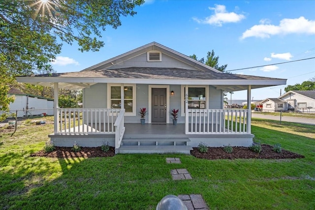 farmhouse inspired home featuring covered porch and a front yard