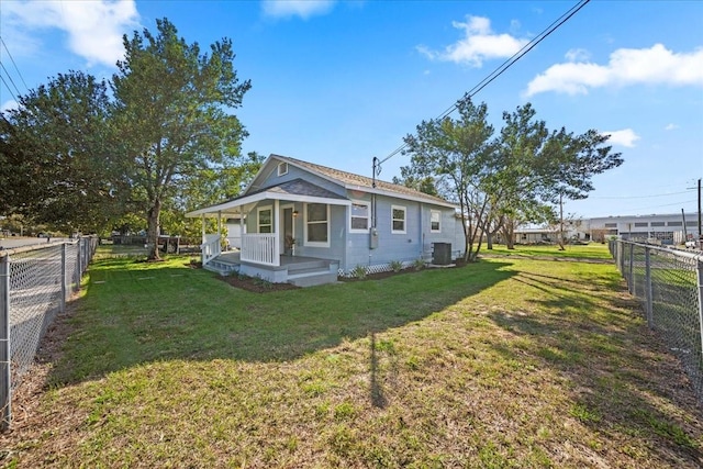 exterior space with a yard, cooling unit, and covered porch