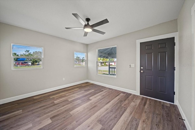 foyer entrance with hardwood / wood-style flooring and ceiling fan