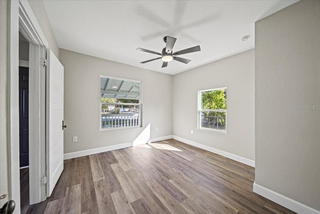 empty room with hardwood / wood-style flooring and ceiling fan