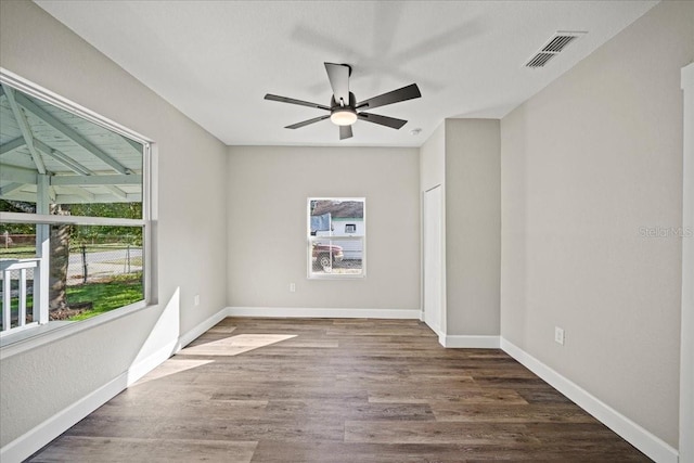 spare room featuring dark wood-type flooring and ceiling fan