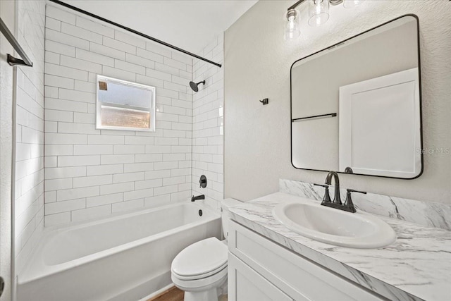 full bathroom with vanity, toilet, and tiled shower / bath combo