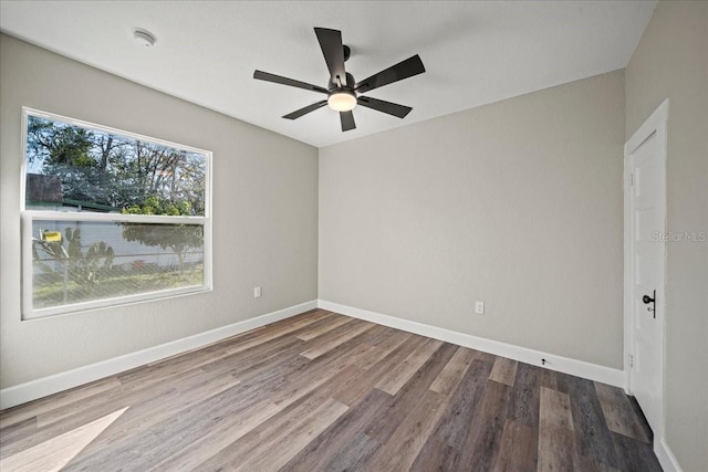 spare room featuring hardwood / wood-style floors and ceiling fan