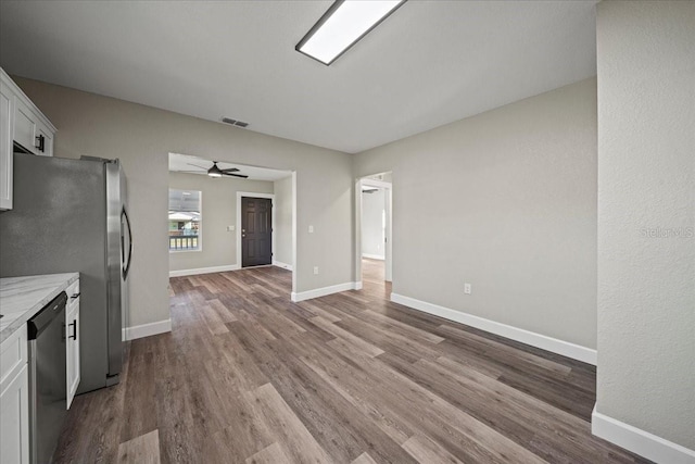 kitchen featuring white cabinetry, dishwasher, ceiling fan, light stone countertops, and light hardwood / wood-style floors