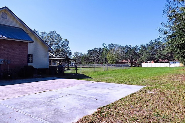 view of basketball court with a yard