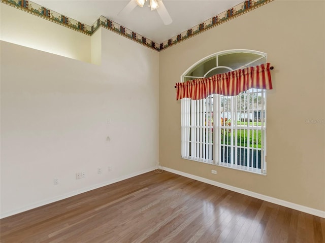 unfurnished room featuring hardwood / wood-style floors and ceiling fan