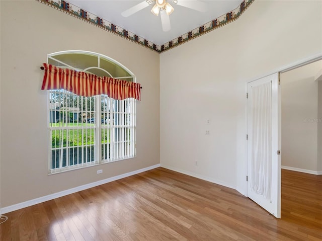 empty room featuring hardwood / wood-style floors and ceiling fan