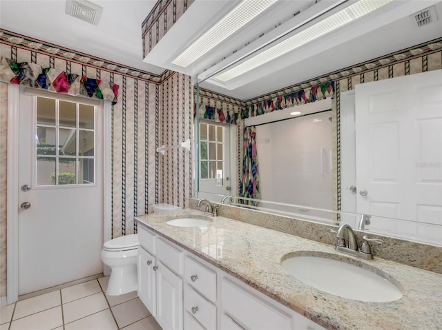 bathroom with tile patterned floors, toilet, and vanity