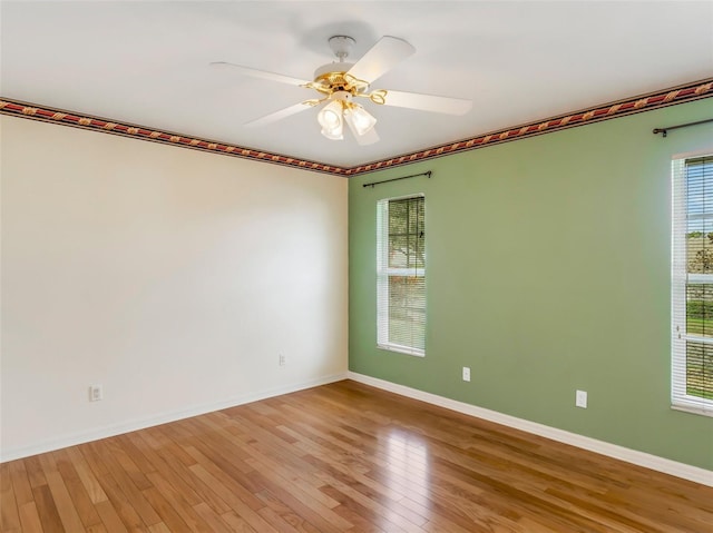 spare room featuring ceiling fan and light hardwood / wood-style flooring