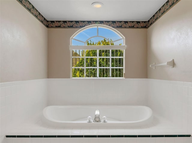 bathroom with tiled bath