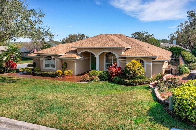 mediterranean / spanish home with a front lawn