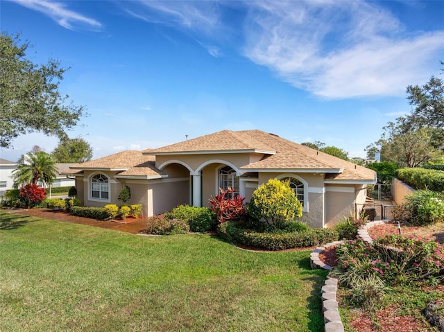 mediterranean / spanish home featuring a front lawn