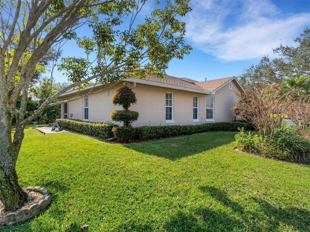 view of property exterior with a yard