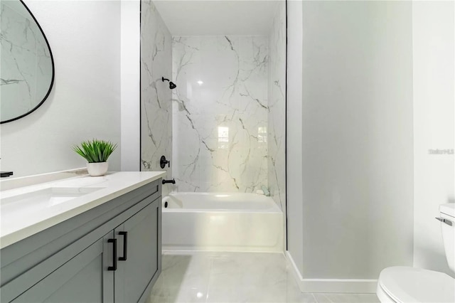 bathroom featuring vanity, toilet, washtub / shower combination, and baseboards