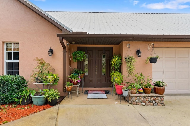 view of exterior entry with a garage