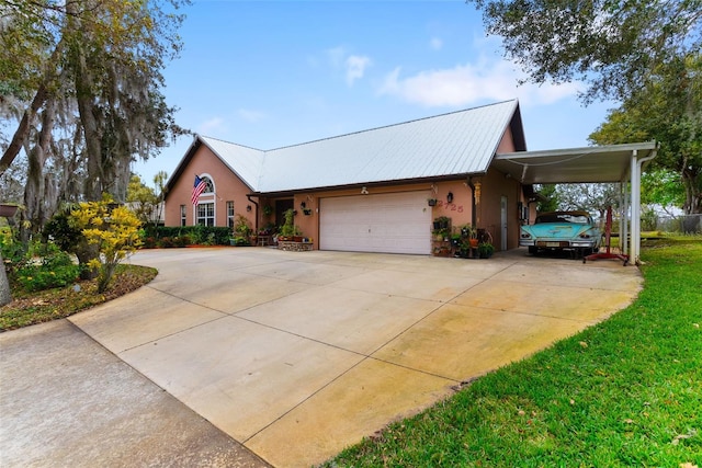 view of front of home featuring a carport, a garage, and a front lawn