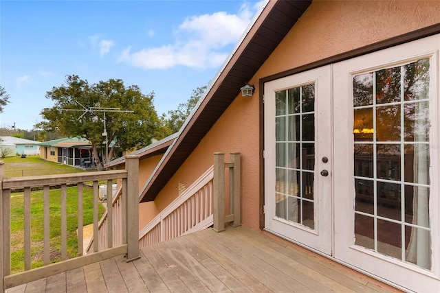 wooden deck featuring a lawn