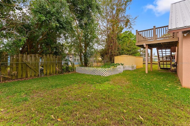 view of yard with a storage unit and a deck