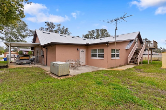 back of property with a yard and a deck