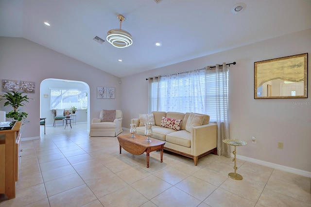 living room featuring vaulted ceiling and light tile patterned flooring