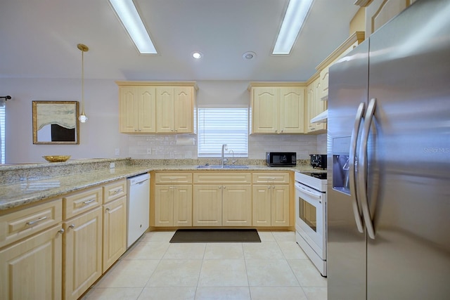 kitchen featuring decorative light fixtures, sink, light stone countertops, light brown cabinets, and white appliances