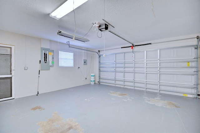 garage with a garage door opener and electric panel