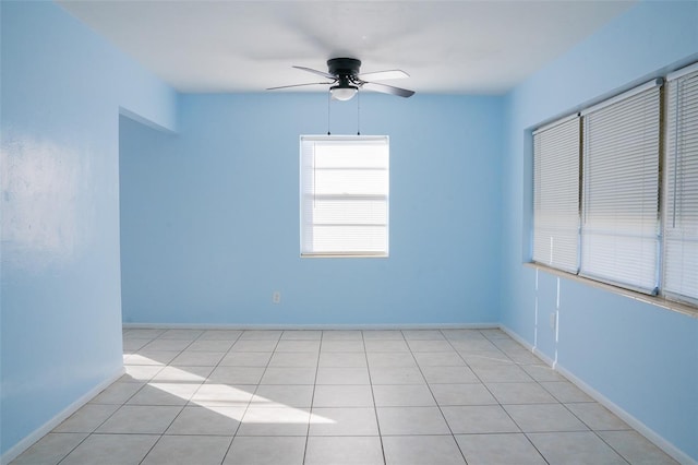 tiled empty room featuring ceiling fan