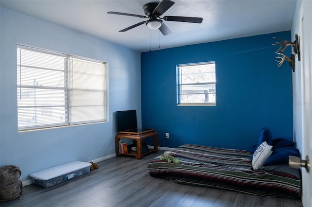 bedroom with hardwood / wood-style floors and ceiling fan