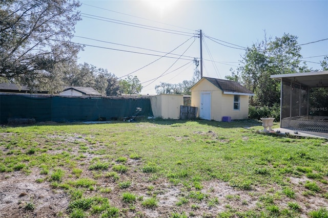 view of yard with a shed and a sunroom