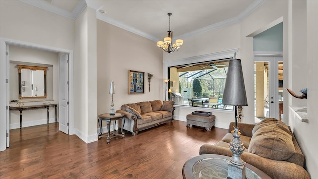 living room featuring crown molding, dark hardwood / wood-style floors, and a notable chandelier