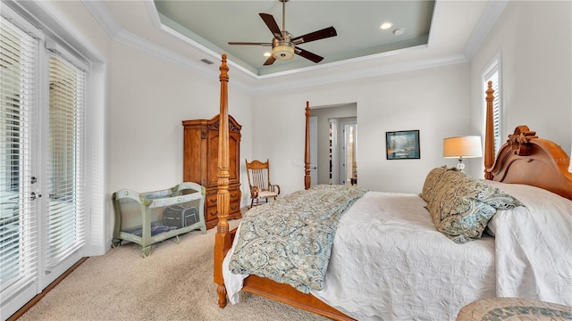 bedroom with light carpet, a tray ceiling, access to outside, and ornamental molding