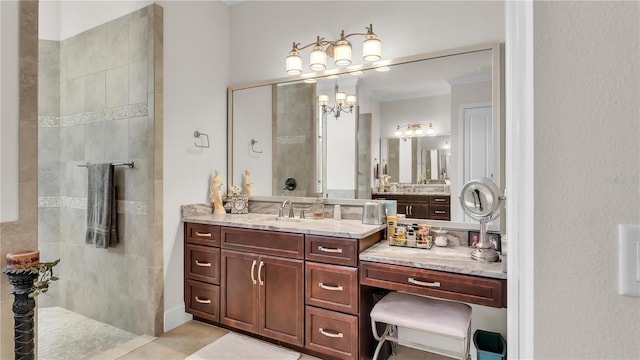 bathroom with crown molding, vanity, and a tile shower