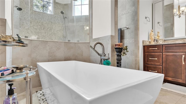 bathroom featuring vanity, shower with separate bathtub, and tile walls